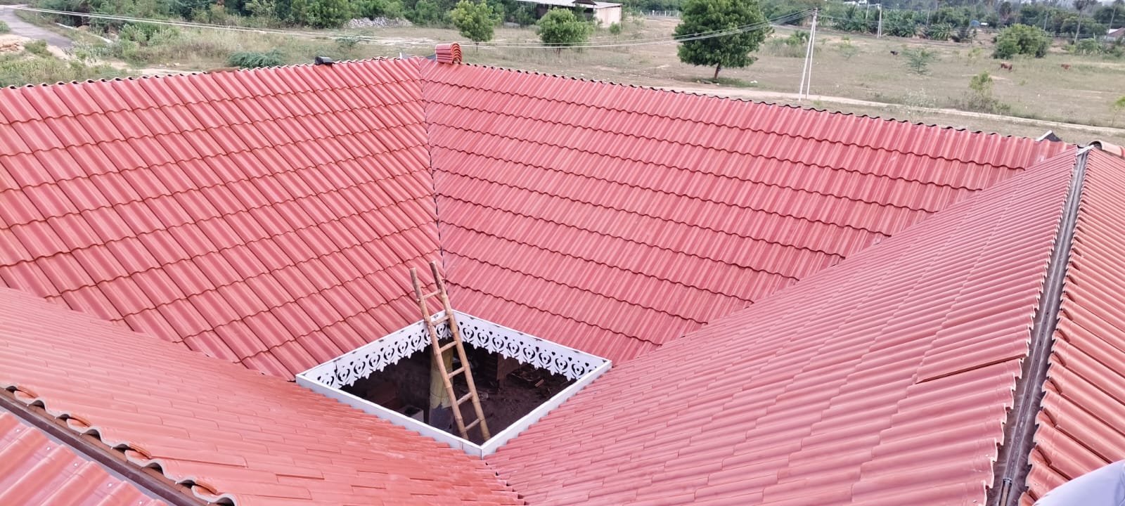 Large residential sloped roof with stone coated terracotta tiles