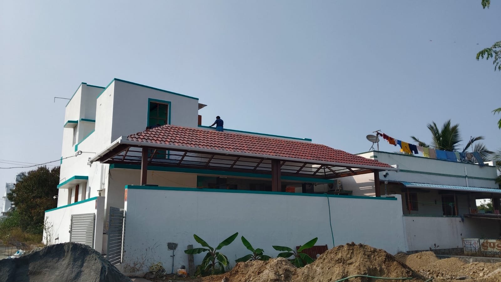 White house with red clay tile canopy over terrace