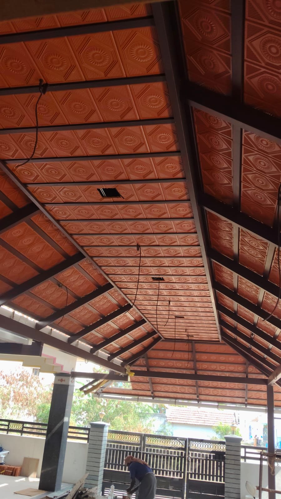 Car porch interior with embossed ceiling panels and steel frame
