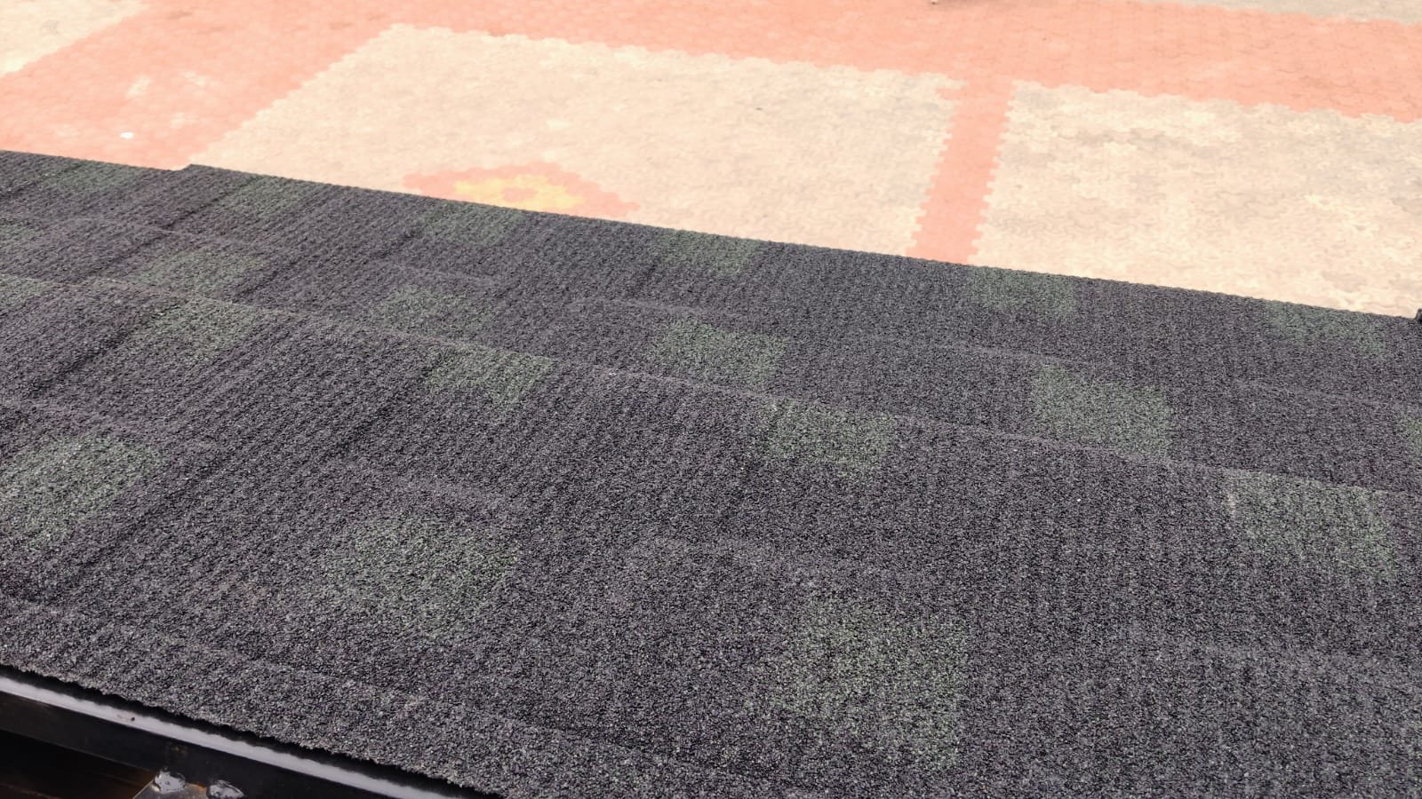 Close-up of dark grey asphalt shingles roof finish