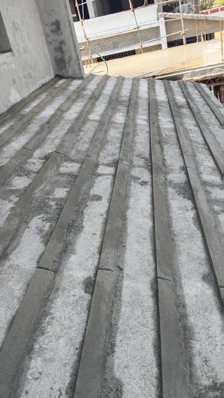 Concrete sloped roof base with cement screed strips prepared