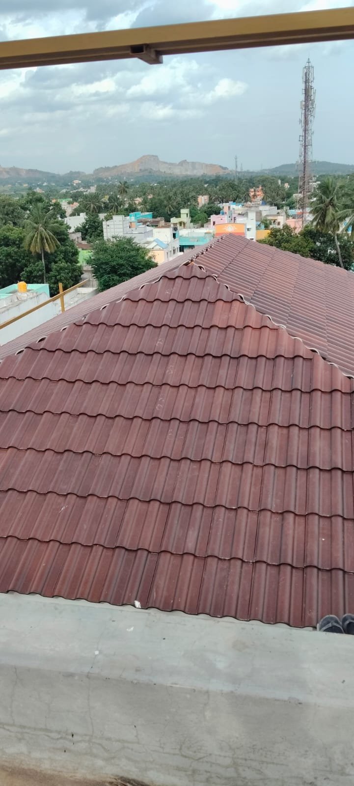 Hip roof completed with red-brown terrace tiles overlooking town