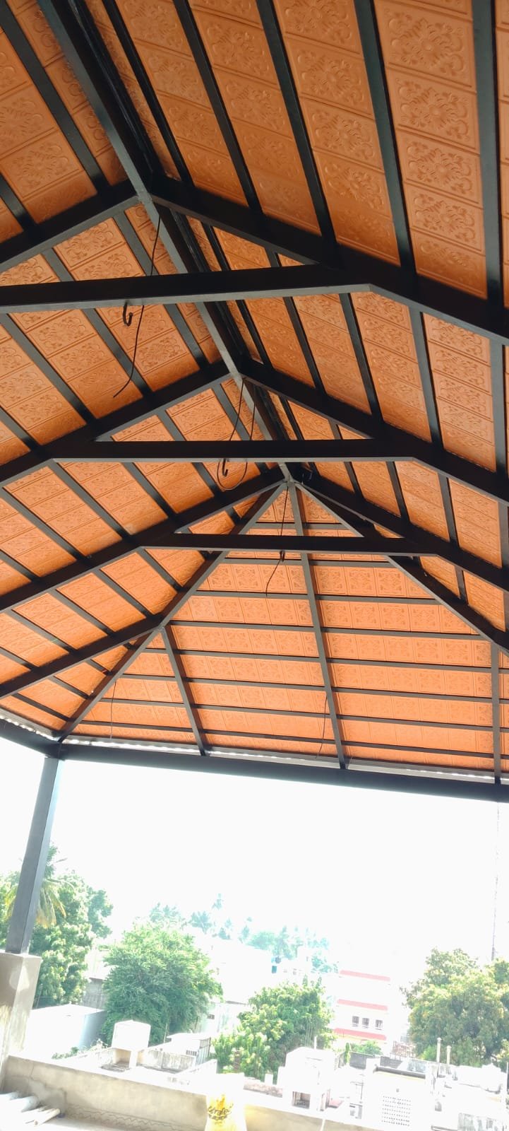Gazebo roof underside with steel trusses and embossed ceiling panels
